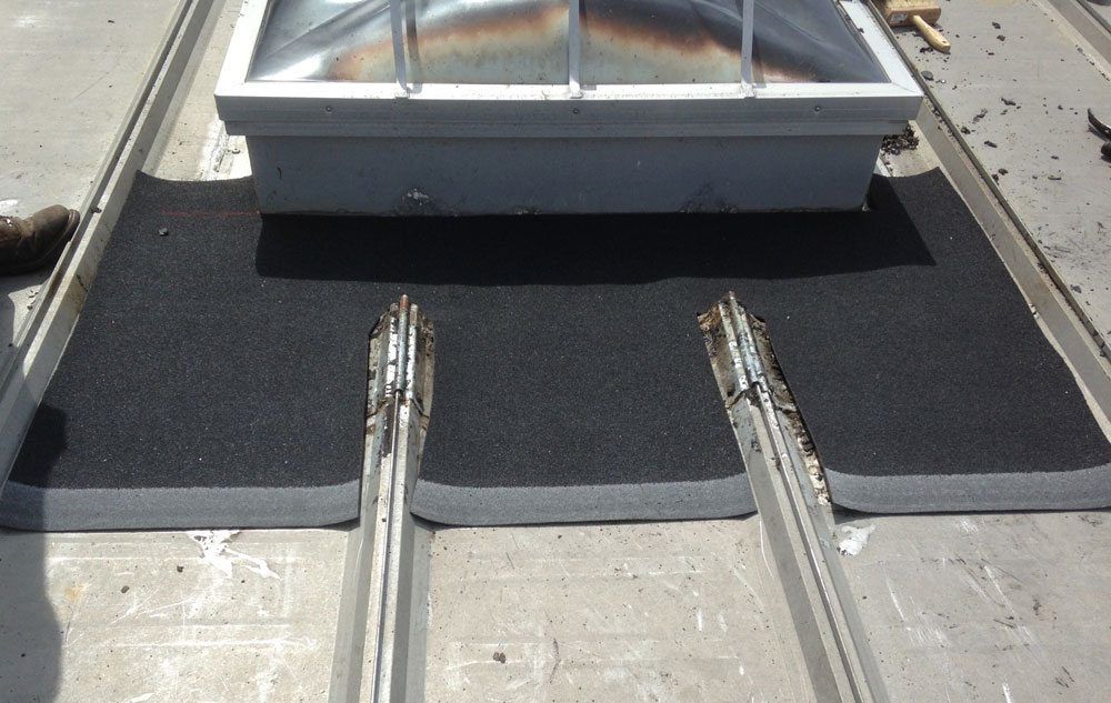 Cut a rubber membrane to size to use as flashing Cut a rubber membrane to size to use as flashing