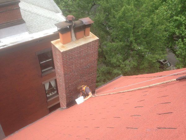 Rappelling to repair flashing on a chimney in Brooklyn, NY. Rappelling to repair flashing on a chimney in Brooklyn, NY.