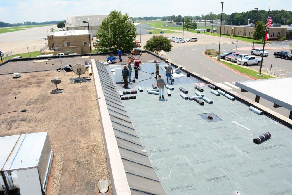 Clean Cut Roofing - Flat roof Installation on East Texas Regional Airport Working on a commercial flat roof in East Texas Regional Airport.