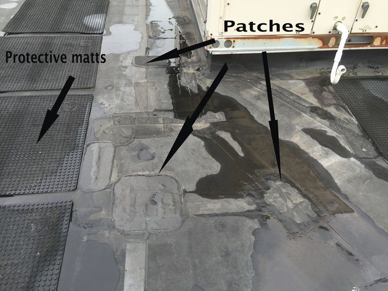 EPDM Roofing Problems - This image shows many repair patches where adhesives have failed due to harmful UV rays. EPDM Roofing Problems - This image shows many repair patches where adhesives have failed due to harmful UV rays.