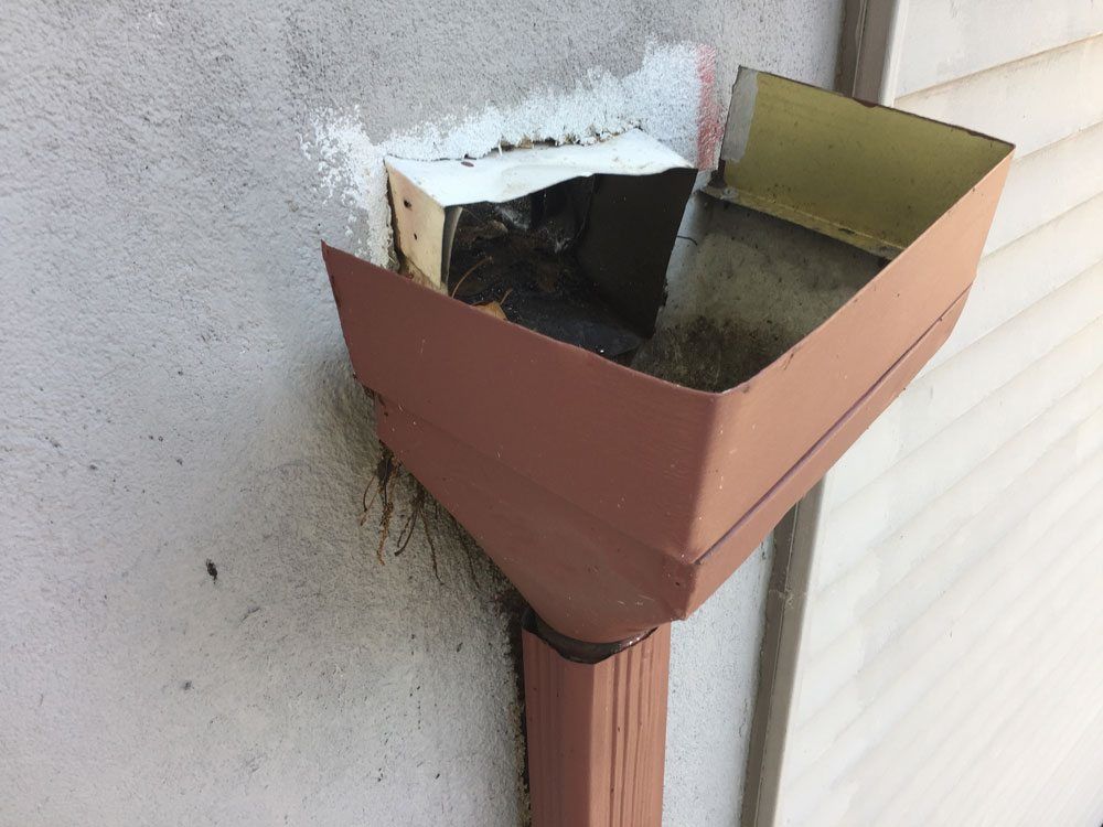 Scuppers flat roof repair - Leader Header not attached to wall causing scupper to leak
